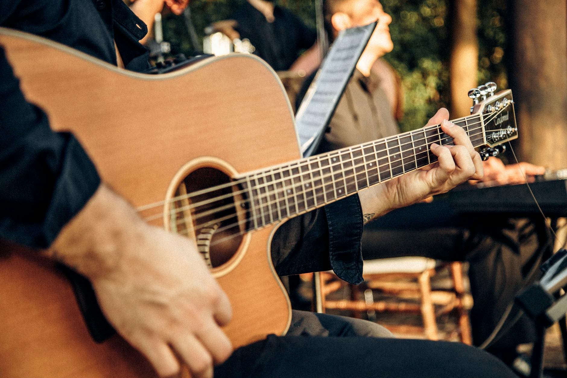 hands of man playing guitar