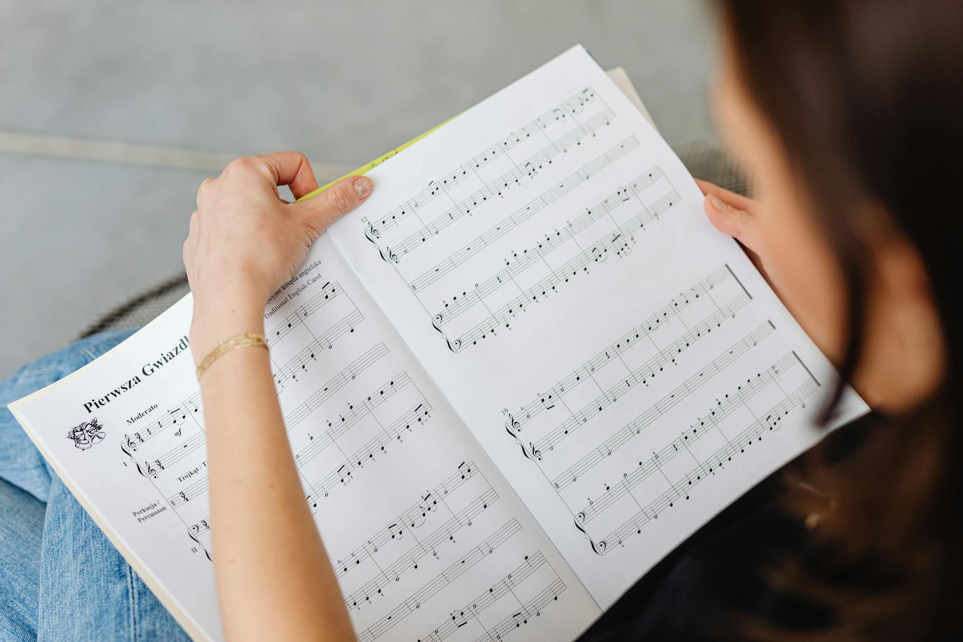 a person holding musical sheets