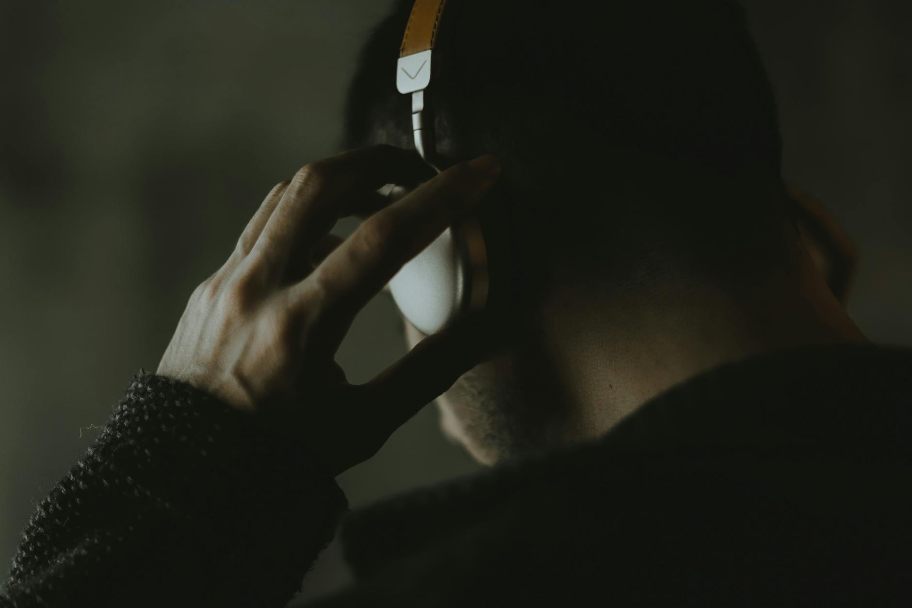 man wearing a headset and listening