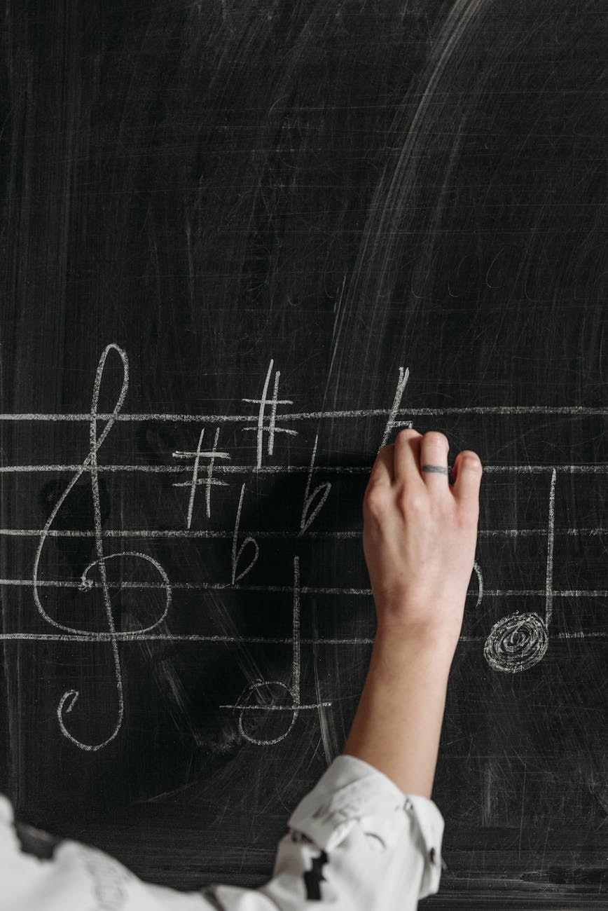 a person writing a musical notation