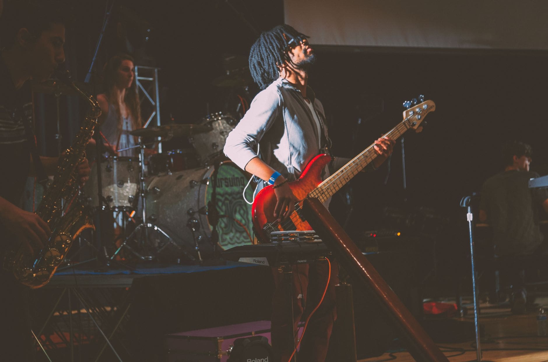 man standing while playing guitar
